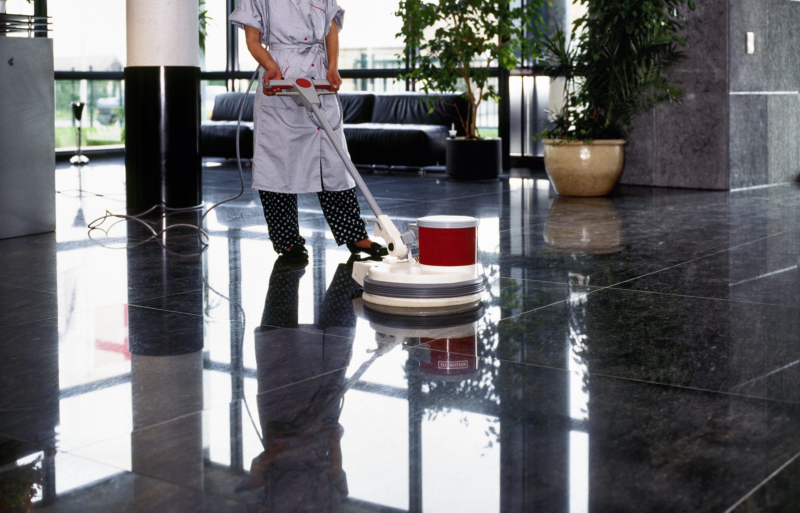 Adult cleaner maid woman with uniform cleaning corridor pass flo