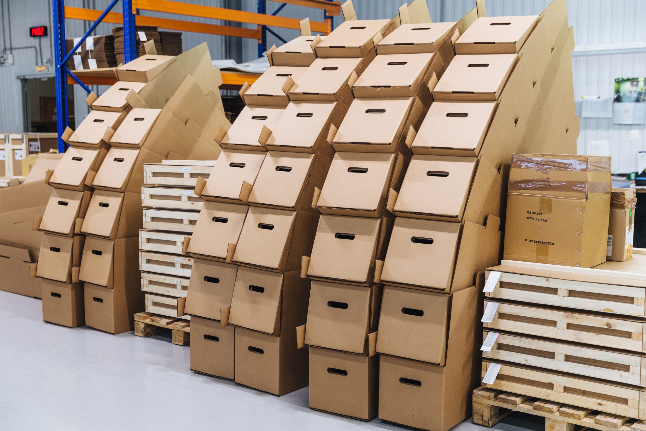 Many paper boxes against storehouse interior. Cardboard boxed in industry warehouse store. Logistic company. Delivery and distribution concept.